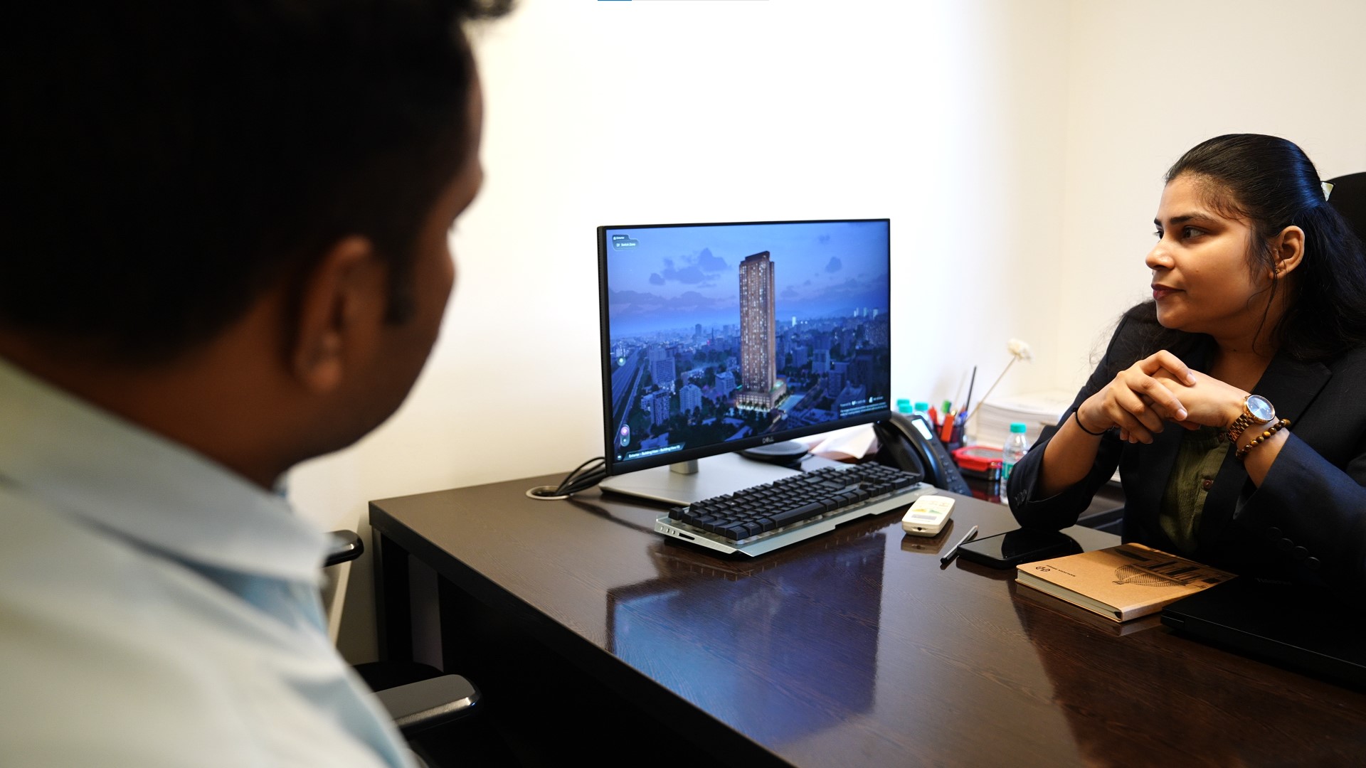 Buyer consultation with real estate digital twin on desktop screen