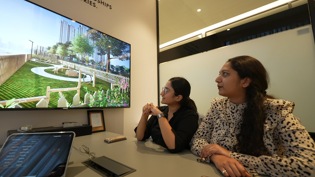 Buyers viewing an interactive amenity visualization during a real estate presentation