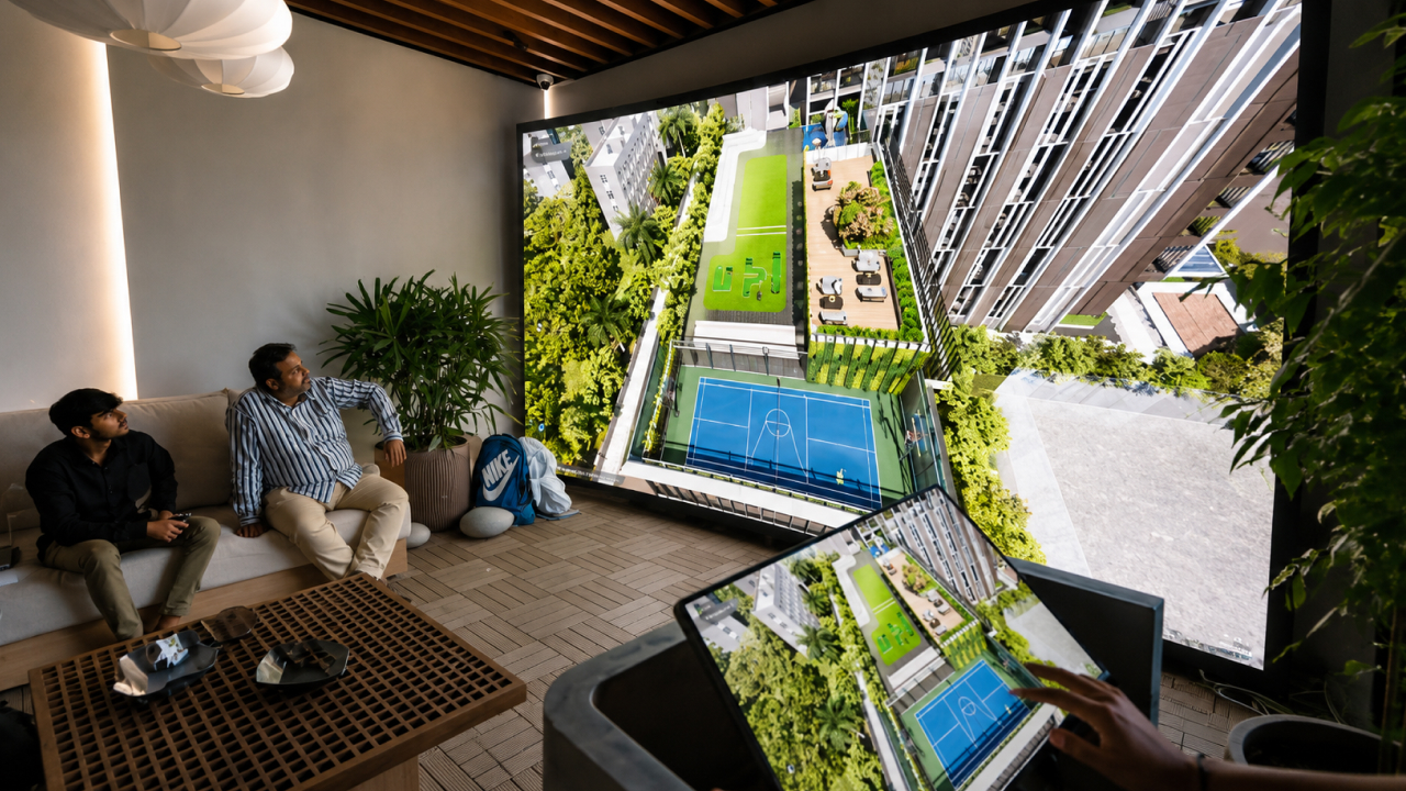 Buyers viewing interactive 3D amenity walkthrough in real estate sales lounge