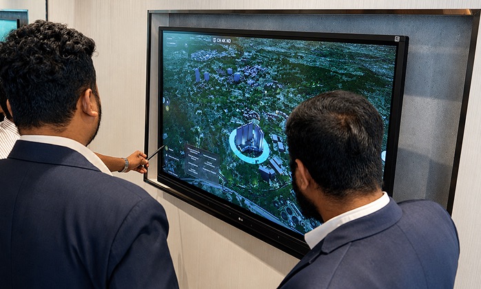 Buyers viewing real estate vicinity map on digital twin display