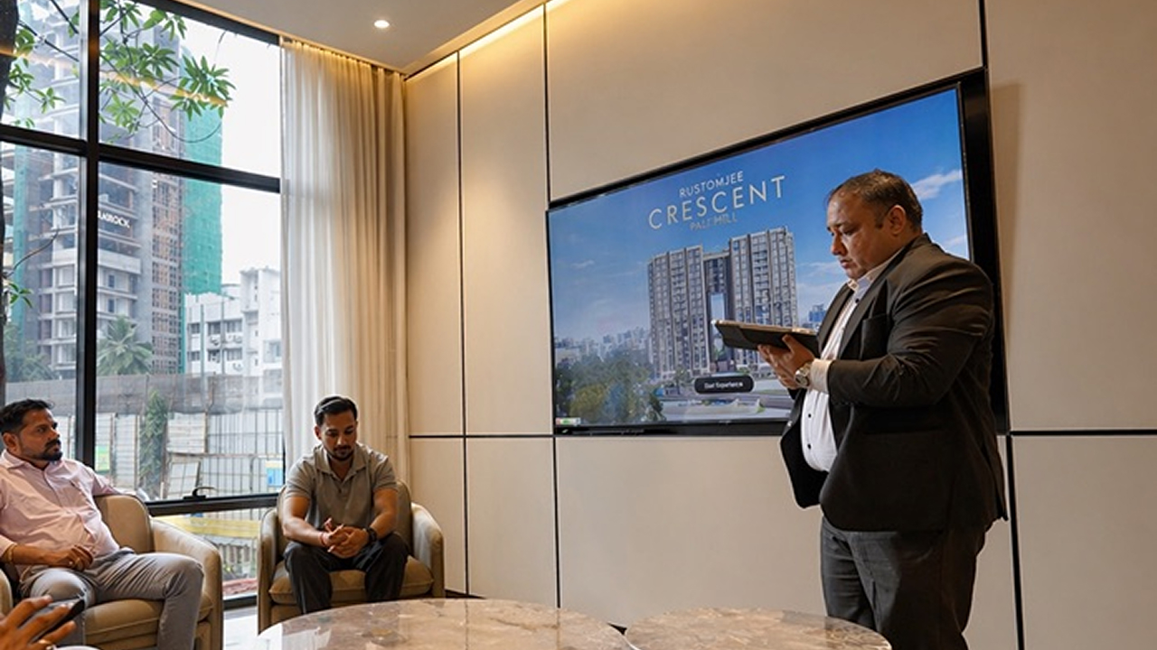 Sales team presenting Rustomjee Crescent through interactive 3D visualization