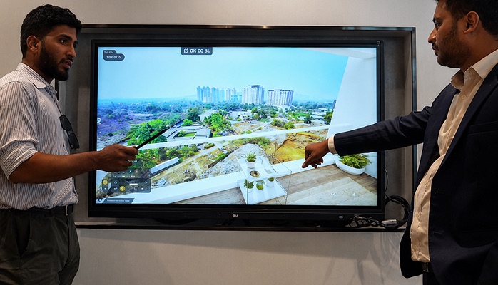 Sales team presenting balcony view through 3D visualization