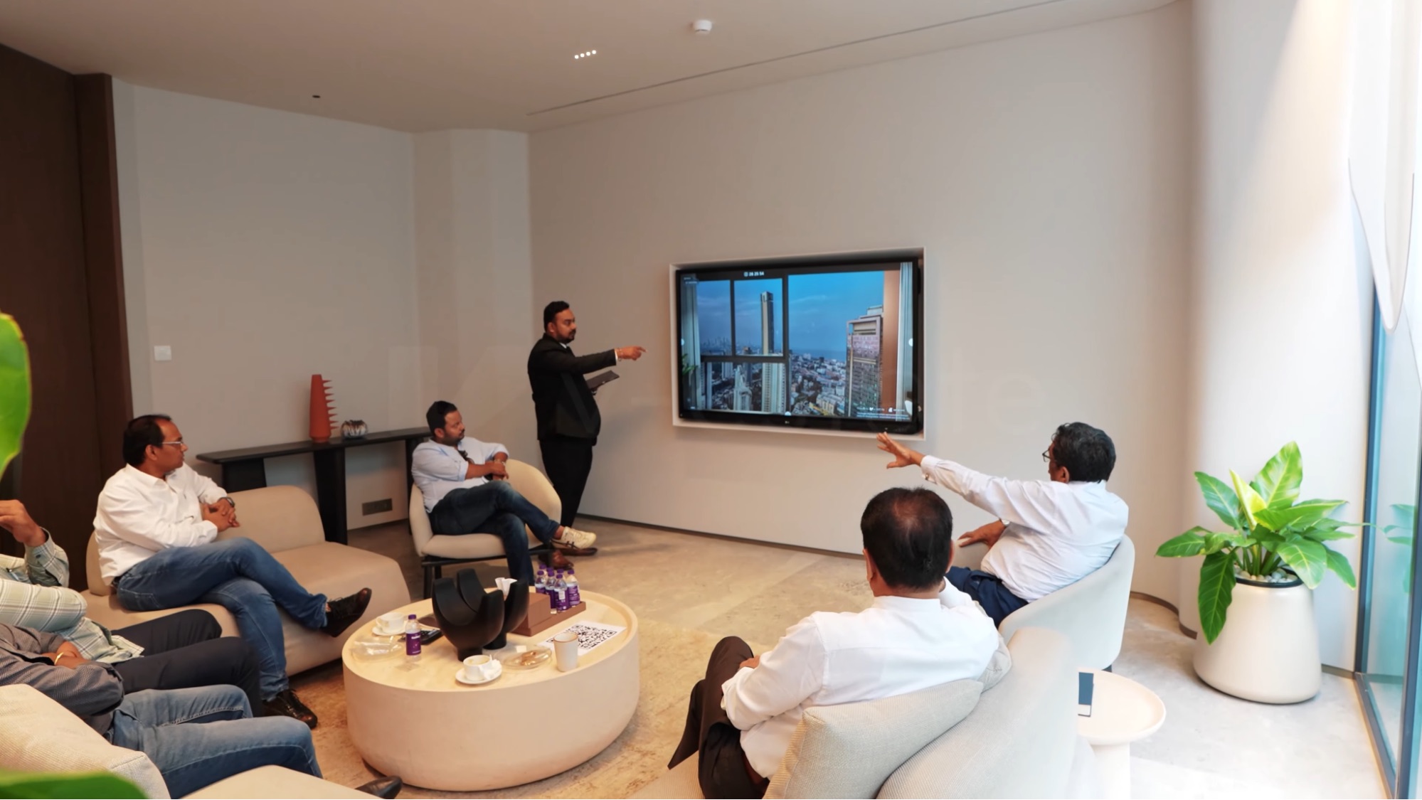 Sales team presents property views through an interactive display.