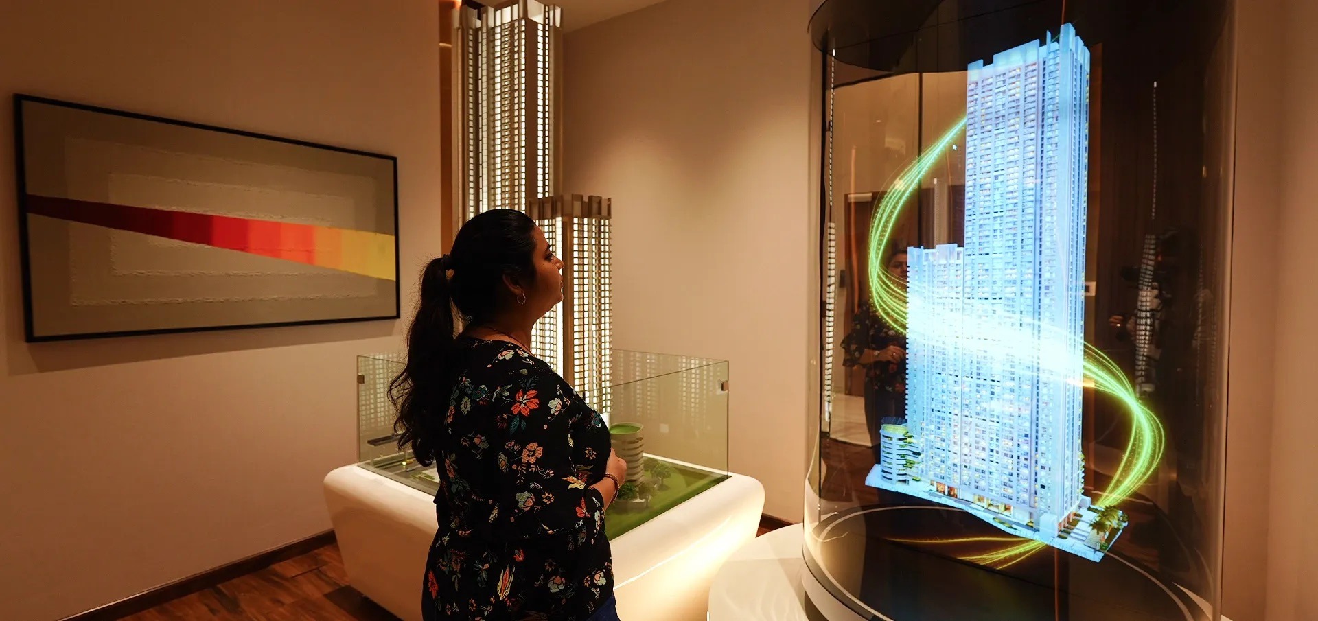 Visitor viewing a holographic residential building model at the L&T Ahana experience centre