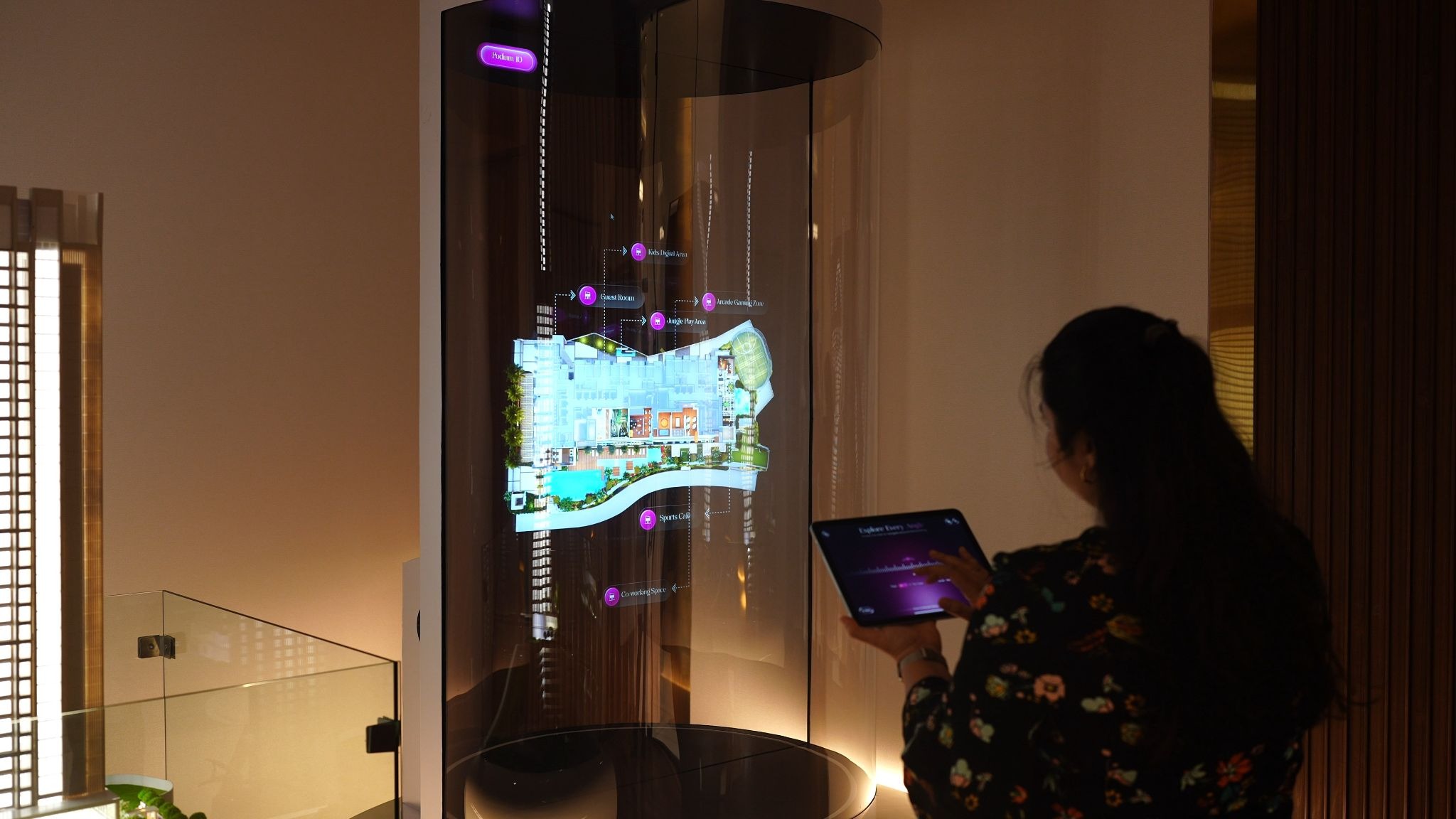 Visitor using a tablet to explore a holographic property model at the L&T Ahana experience centre